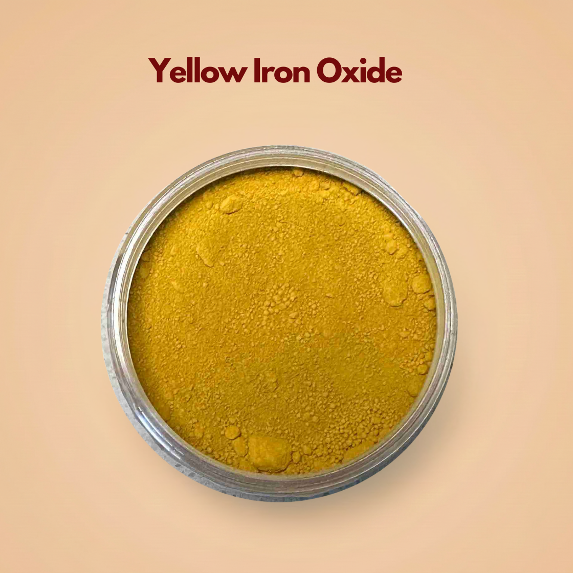 Top view of yellow iron oxide pigment powder in a round container, showing a rich mustard yellow mineral pigment with a soft matte texture and small natural clumps. The surface appears finely milled and evenly distributed against a neutral beige background. This cosmetic iron oxide pigment powder is commonly used for foundation, concealer and mineral makeup formulations.