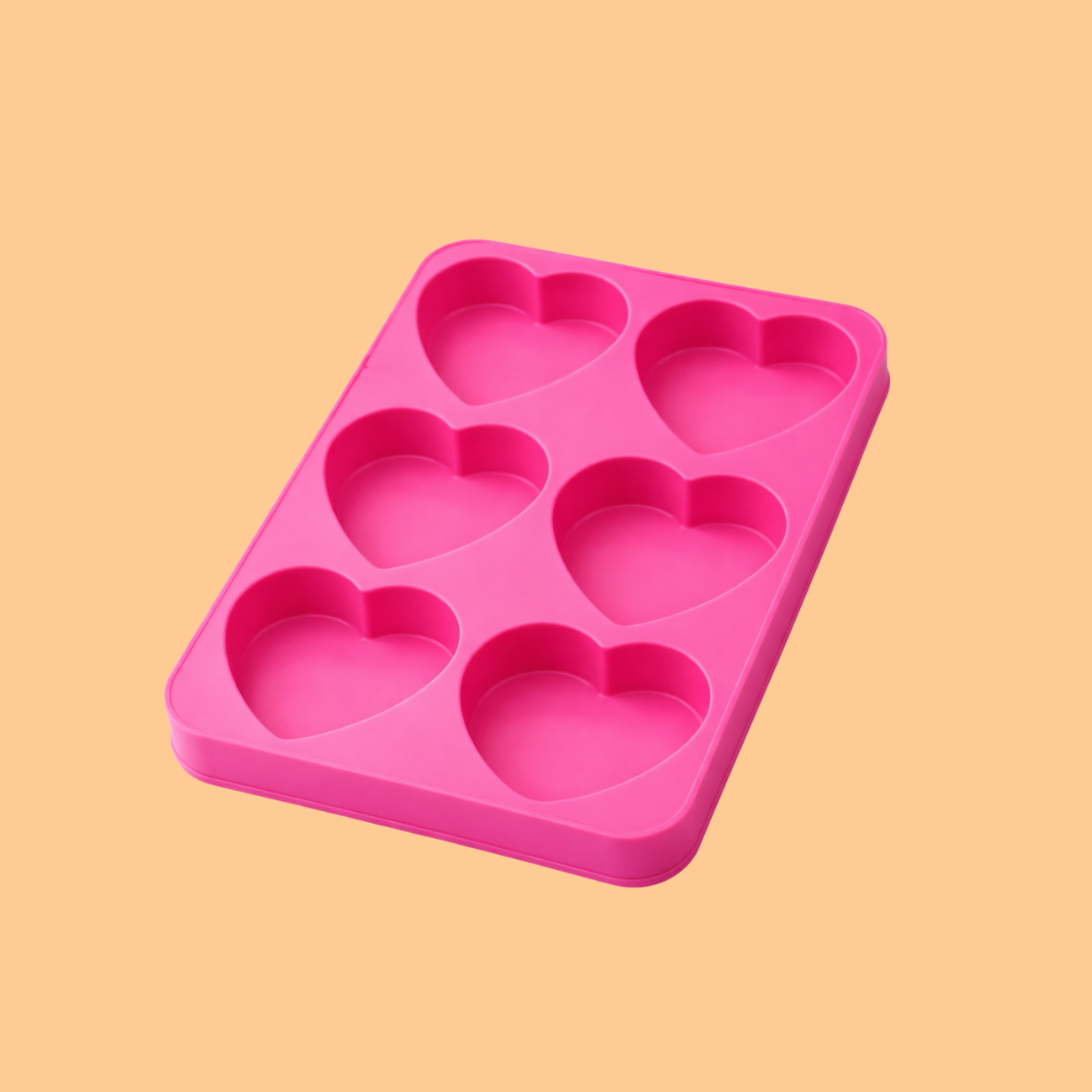 Pink silicone heart soap mould with six decorative floral heart cavities displayed with colorful finished flower shaped soap bars, silicone mold used for handmade decorative soaps, DIY soap crafting, bath product making and artisan soap production