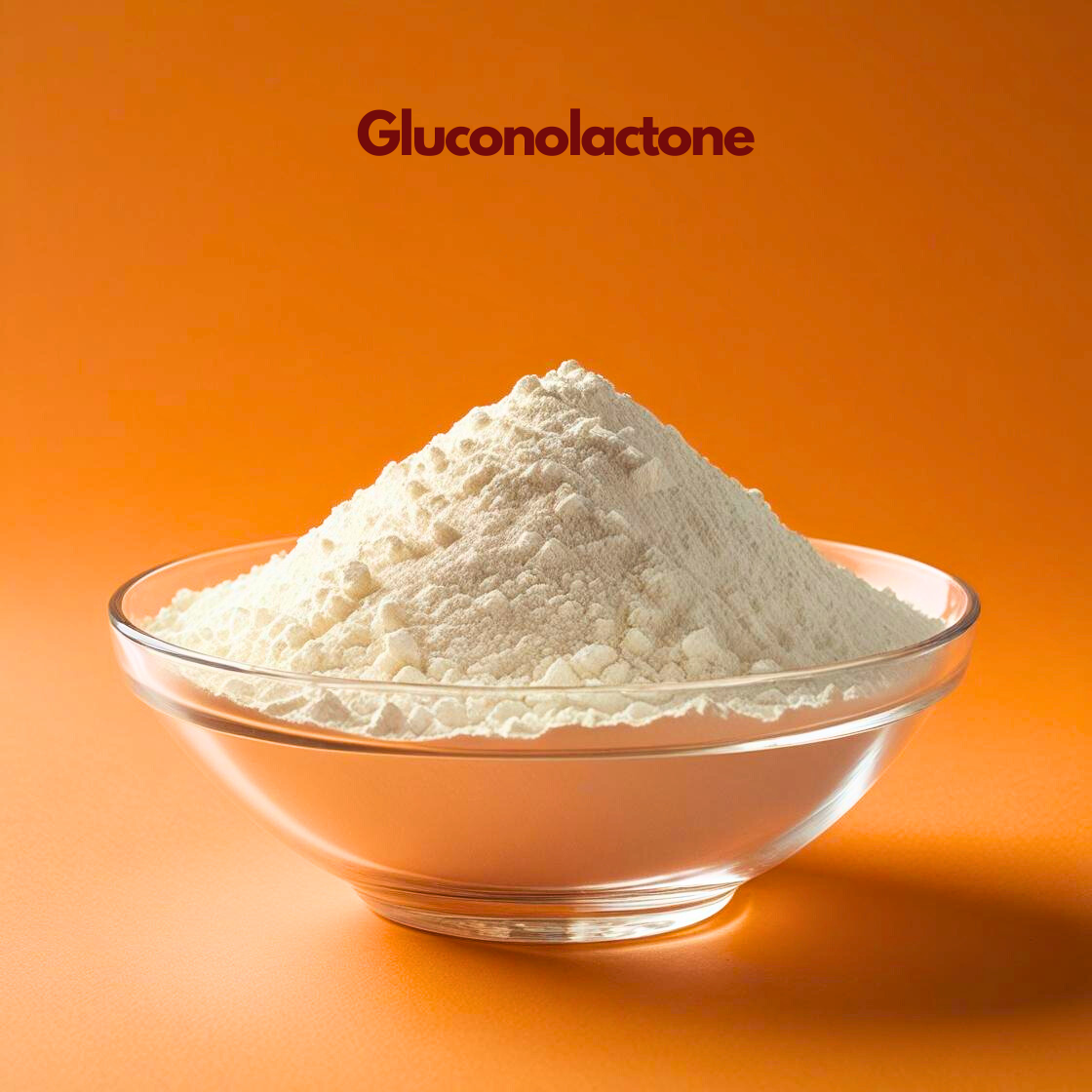 A mound of fine, off white Gluconolactone powder with a soft, uniform texture inside a clear glass bowl. The image features a bold, solid orange background that makes the light colored powder stand out. The name "Gluconolactone" is written in dark maroon at the top center.