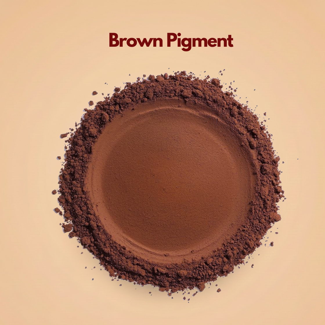 Circular spread of deep brown pigment powder with a smooth matte center and slightly coarse outer texture. Small particles are scattered naturally around the edges against a neutral background. This brown mineral pigment powder is used in foundation shades, bronzers and cosmetic formulations.