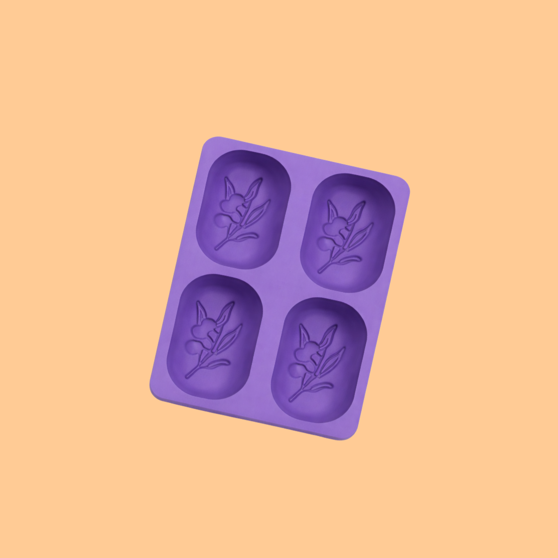  Purple silicone soap mold with four oval cavities featuring embossed floral design inside each cavity, flexible mold used for decorative handmade soaps, DIY soap crafting, and artisan bath product manufacturing.
