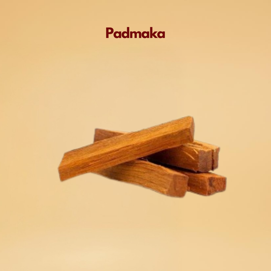 A stack of four reddish brown wood pieces labeled "Padmaka" against a soft beige background. The image conveys a natural and earthy tone.