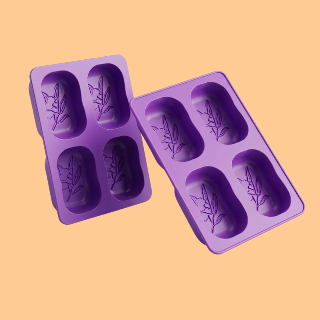 Purple silicone soap mold trays with deep oval cavities and embossed floral patterns designed for handmade soap bars, flexible silicone mold used for DIY soap making, melt and pour soap crafting, and cosmetic soap production.