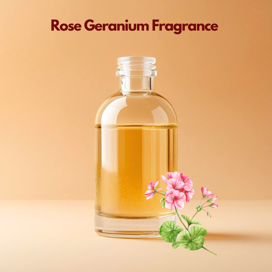 Clear glass bottle containing golden oil labeled Rose Geranium Fragrance set against a soft beige background with pink geranium flowers and green leaves illustrated at the bottom. This oil soluble floral fragrance oil is perfect for soaps, candles, attars, and cosmetic products, offering a fresh rosy scent with a soft herbal undertone.