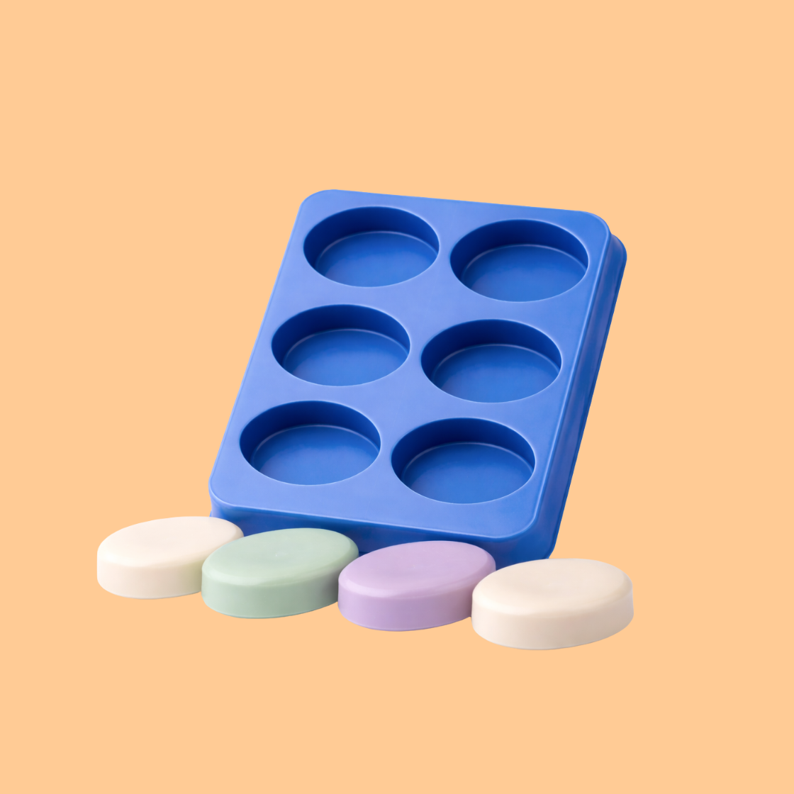 Blue silicone round cavity soap mould tray displayed with four finished pastel colored round soap bars in front, flexible silicone mold used for handmade soap production, artisan soap crafting, and cosmetic bath product making.
