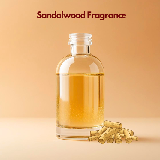 Transparent fragrance bottle labeled Sandalwood Fragrance with stacked sandalwood sticks illustrated beside it. This oil soluble fragrance for cosmetics delivers a warm woody scent ideal for soaps, oils & traditional formulations.