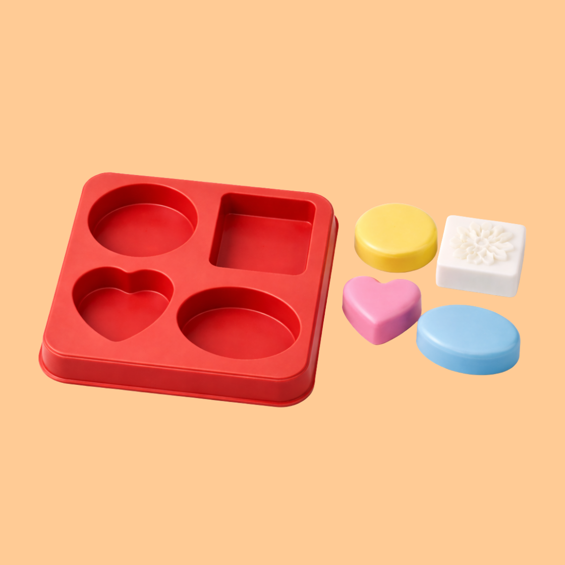 Mix Red design silicone soap mold with four different designs (heart, oval, square, rectangular) beside the mould different shapes  colors of soaps are place near mould floral cavities designed for decorative handmade soap bars, flexible mold used for DIY soap crafting, bath soap making, and artisan cosmetic soap production.
