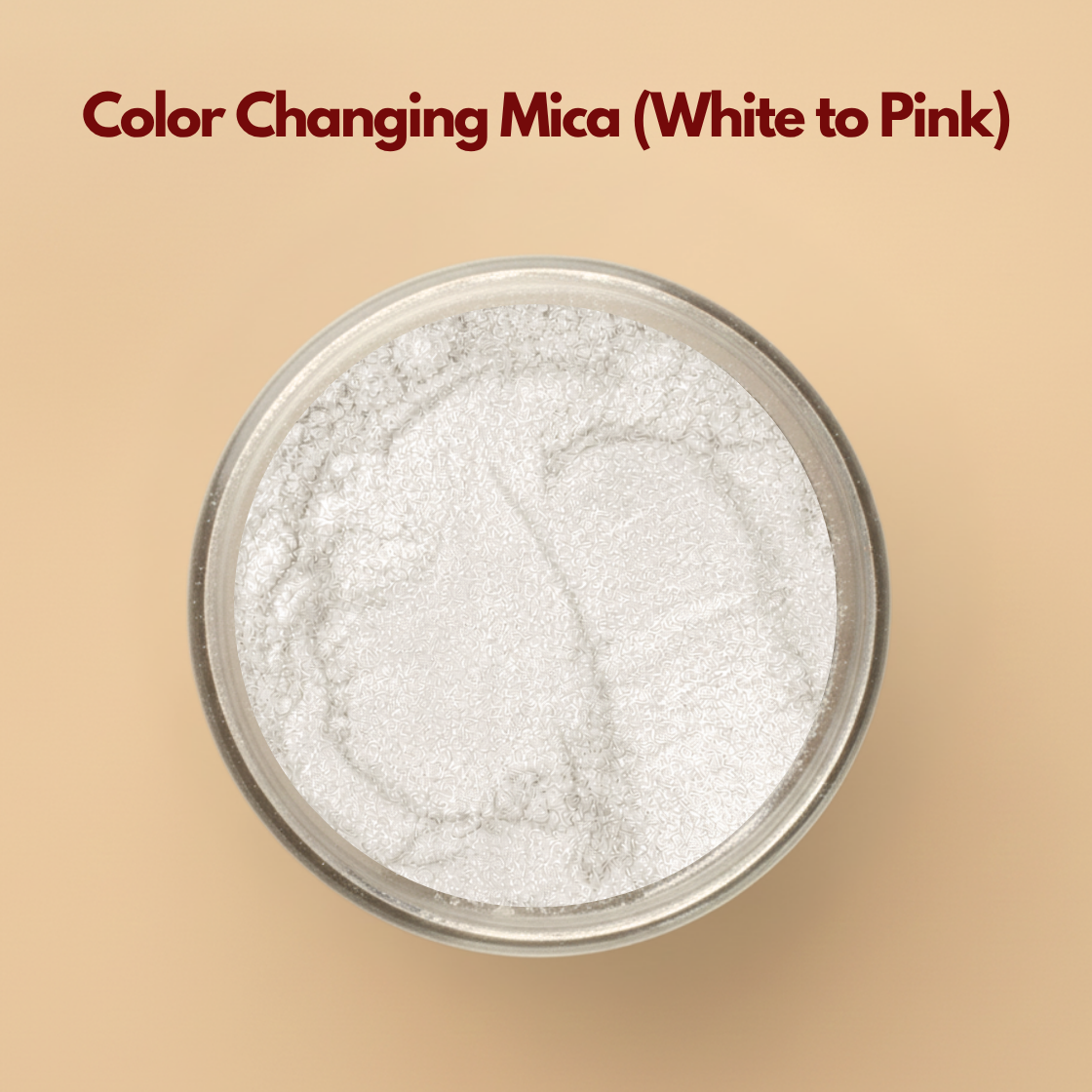 Color changing mica powder white to pink displayed in a transparent cosmetic jar on a neutral beige background. Cosmetic grade thermochromic mica pigment designed for skincare, soap making, lip gloss, makeup, resin art, and DIY cosmetic formulations. The image highlights the fine white shimmer powder before activation or application.