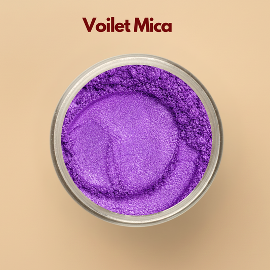Violet mica powder with vibrant purple shimmer displayed in a round transparent jar on a beige background. Cosmetic grade purple mica pigment used in soap making, lip gloss, bath bombs, makeup, skincare formulations, and handmade cosmetic products. The image highlights rich violet metallic shimmer and finely milled pigment texture.