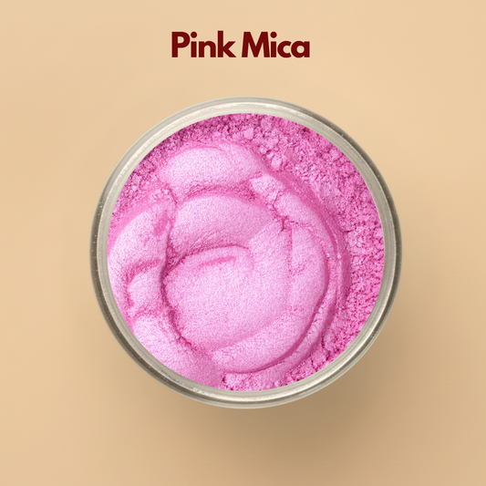 Pink mica pigment powder in a transparent cosmetic container featuring bright pink shimmer and fine powder texture. Cosmetic grade mica powder for lip gloss, soap making, skincare, blush formulations, makeup products, bath bombs, and DIY cosmetic applications. The image displays vibrant pink shimmer pigment commonly used in beauty and handmade cosmetic formulations.