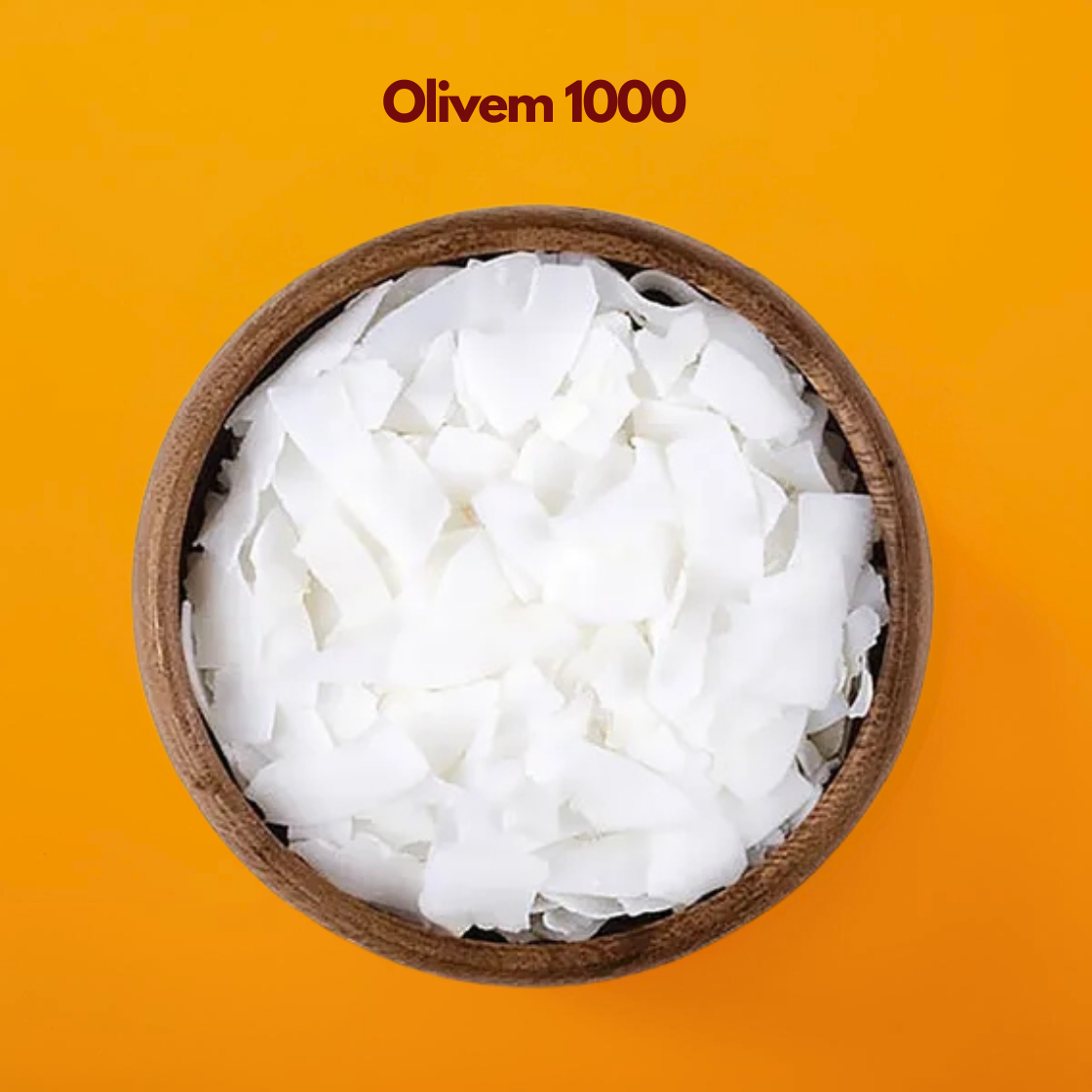 Wooden bowl filled with white wax flakes labeled "Olivem 1000" placed on a bright orange background. Olivem 1000 is a natural olive derived cosmetic emulsifier used in skincare formulations to create stable creams lotions and moisturizing emulsions.