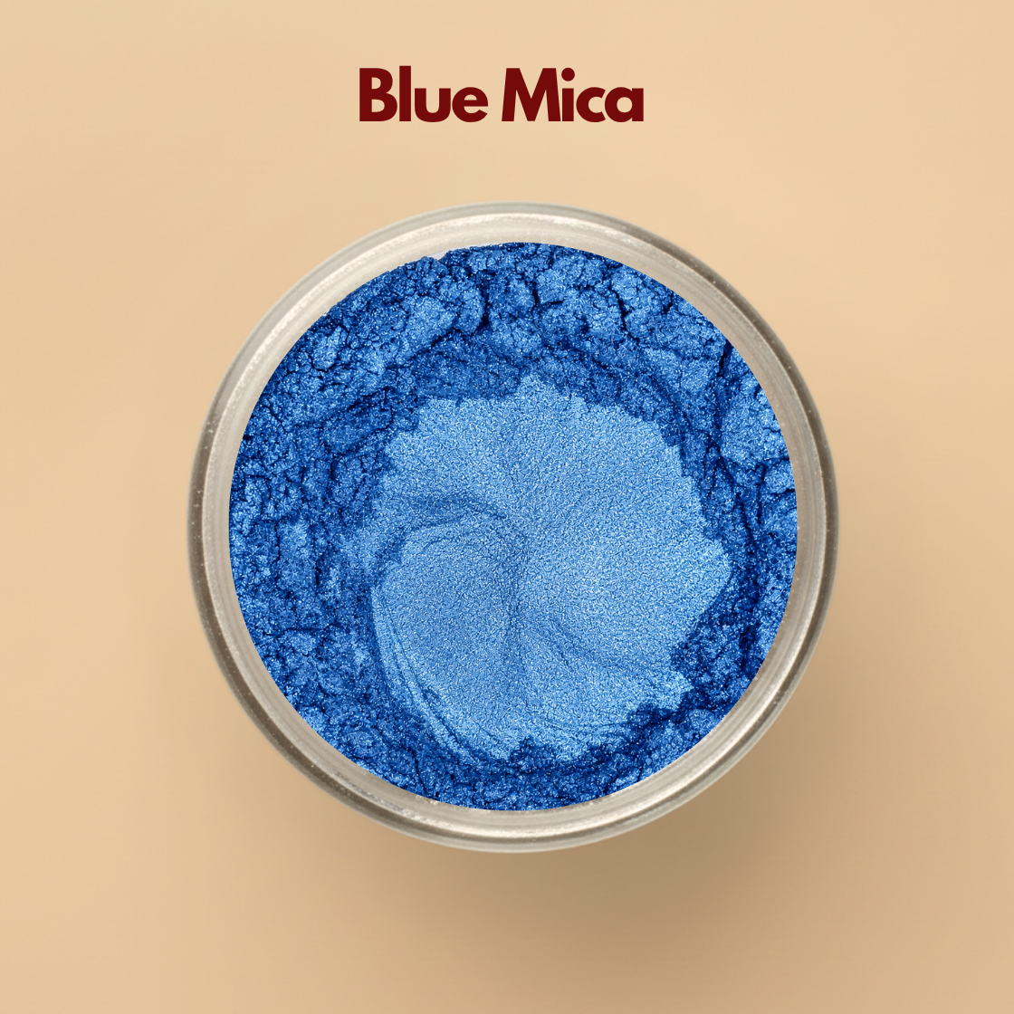 Blue mica powder with rich metallic shimmer displayed in a round transparent cosmetic jar on a beige background. Cosmetic grade blue mica pigment used in soap making, lip gloss, makeup, bath products, skincare formulations, candles, and DIY cosmetic applications. The image highlights vibrant blue shimmer pigment and smooth fine mica powder texture.