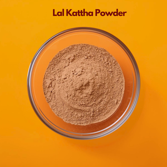 Top angle close up of Lal Kattha Powder in a transparent glass bowl on an orange background, revealing finely ground reddish brown herbal powder with smooth texture. Botanical cosmetic powder used in traditional herbal formulations, natural coloring applications and Ayurvedic skincare blends.

