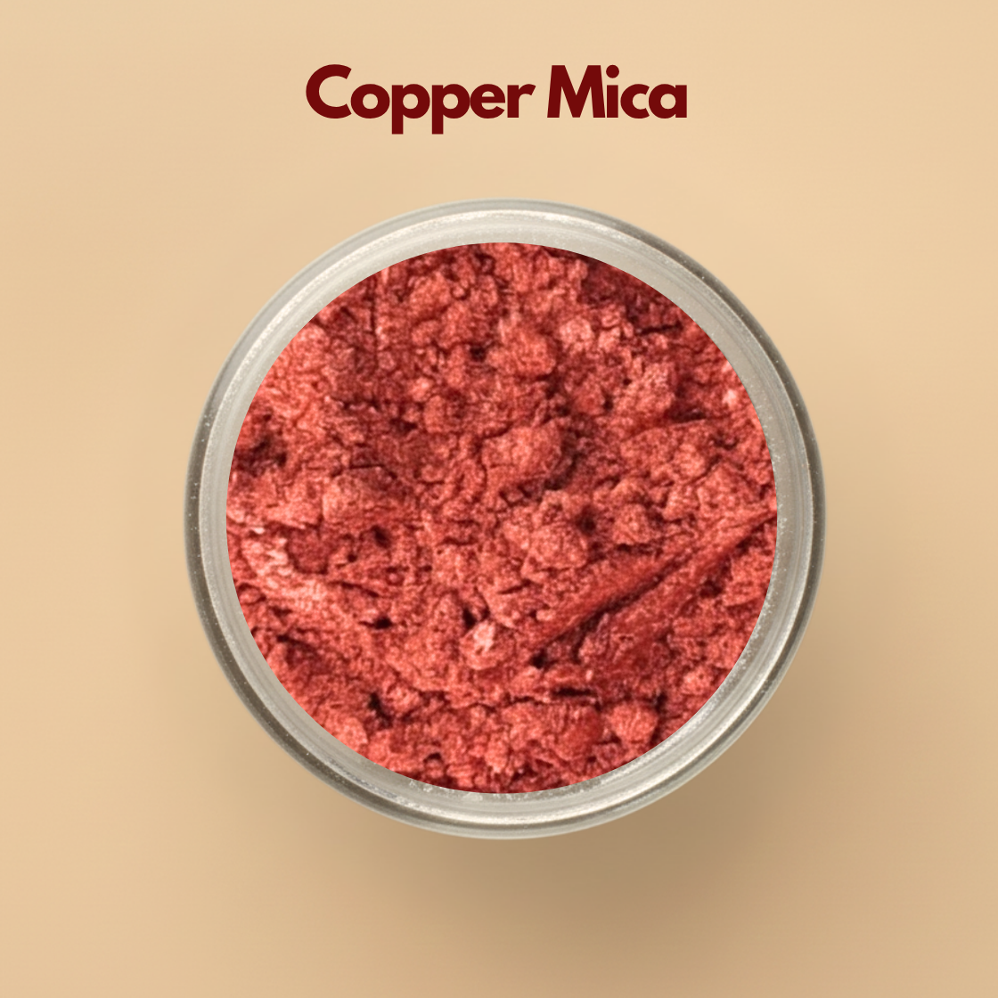 Copper mica powder with metallic shimmer texture displayed in a round transparent cosmetic jar on a beige background. Cosmetic grade copper mica pigment used in skincare formulations, soap making, makeup products, candles, lip gloss, and DIY cosmetic manufacturing. The image highlights rich copper shimmer with reflective metallic cosmetic pigment appearance.