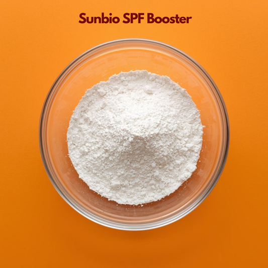 Top view of a glass bowl filled with fine white powder labeled "Sunbio SPF Booster" placed on a bright orange background. Sunbio SPF Booster is a cosmetic sunscreen enhancer used in skincare formulations to improve sun protection efficiency and stability.