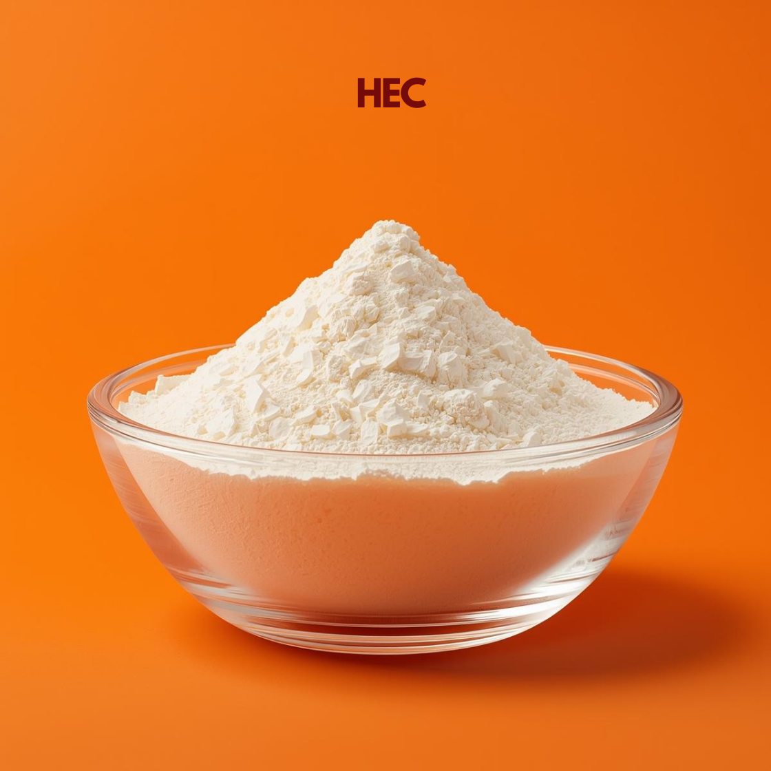 A mound of bright white HEC powder with a slightly coarse, granular texture presented in a clear glass bowl. The background is a solid, warm orange. The acronym "HEC" is centered at the top in bold maroon.
