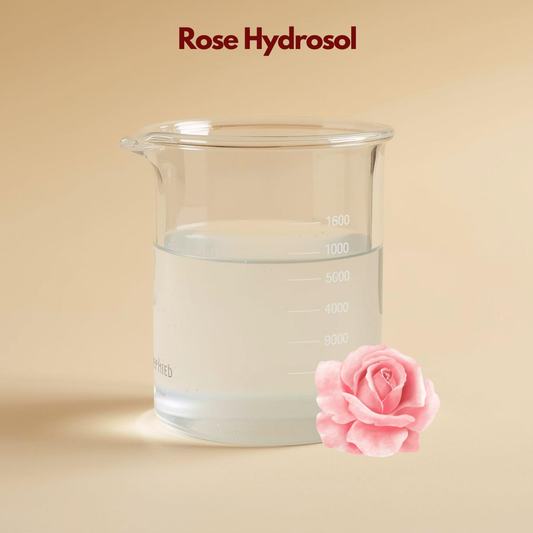 Laboratory beaker with clear liquid labeled Rose Hydrosol featuring a soft pink rose illustration. This rose hydrosol floral water is shown as a hydrating and soothing botanical facial mist.