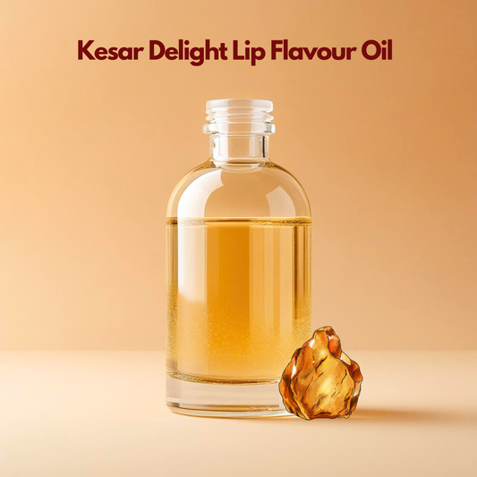 A glass bottle of golden oil labeled "Kesar Delight Lip Flavour Oil" stands against a warm beige background. A saffron flower sits beside it. Elegant and soothing.