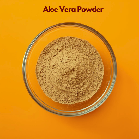 Overhead view of Aloe Vera Powder in a clear glass bowl placed on a vibrant orange surface, showing fine beige herbal powder with soft texture. Plant based aloe powder used in natural skincare masks, soothing cosmetic formulations, hydrating face packs and herbal beauty products.