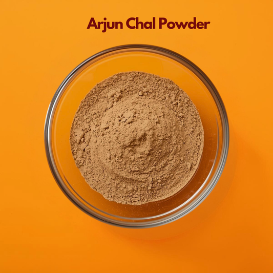 Overhead view of Arjun Chal Powder in a round glass bowl, featuring finely milled light brown herbal powder with a slightly grainy texture on an orange background. Botanical Ayurvedic powder traditionally used in herbal formulations and natural wellness blends.