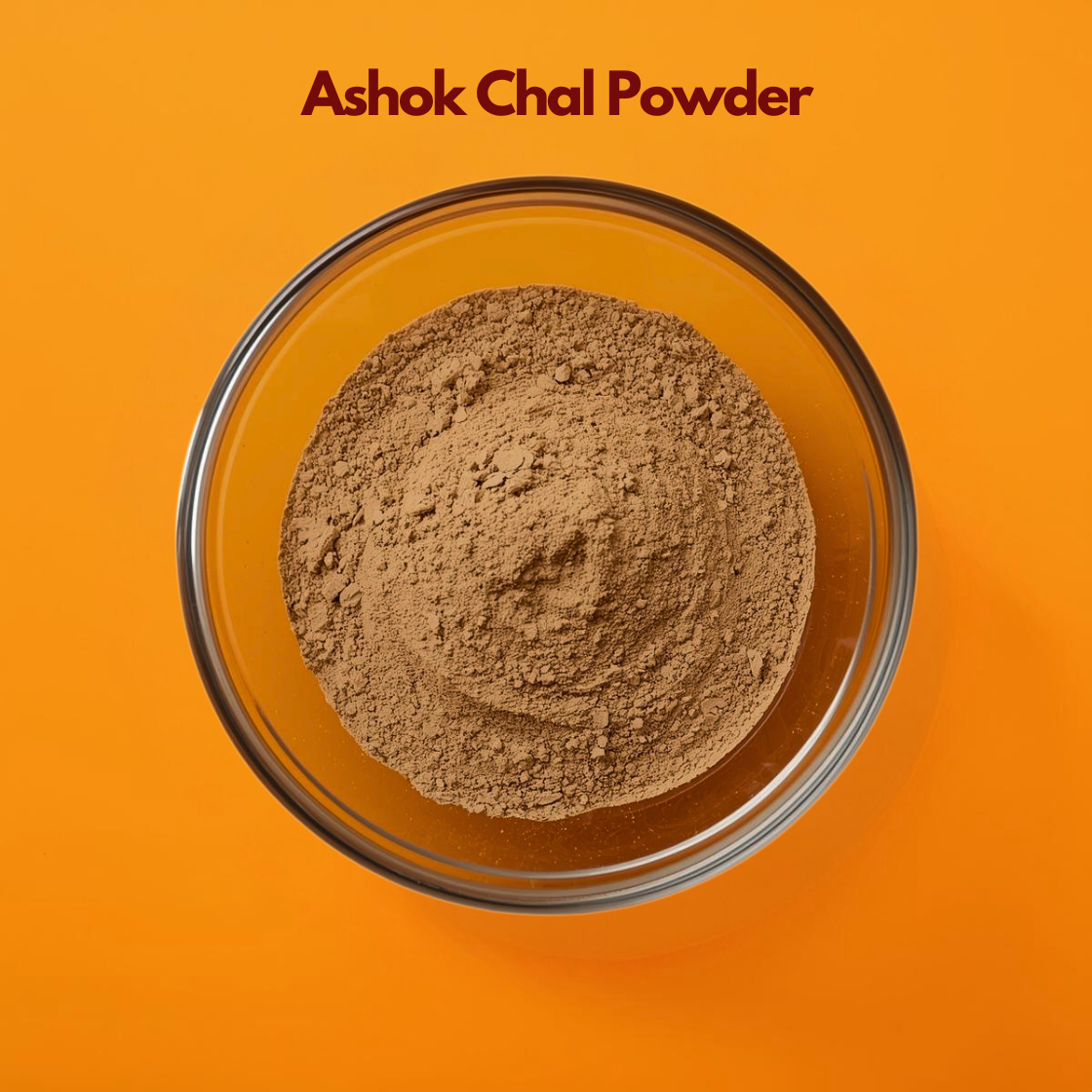  Close up overhead image of Ashok Chal Powder in a clear glass bowl, highlighting its finely milled light brown texture on an orange background. Ayurvedic herbal powder used in traditional botanical formulations and natural wellness preparations.
