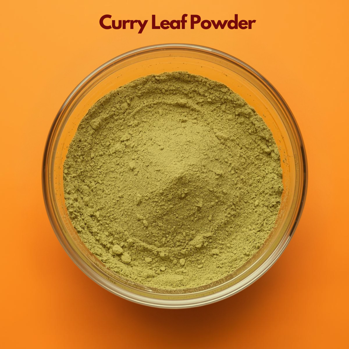 Top view of Curry Leaf Powder in a transparent bowl, showing finely milled green herbal powder with soft texture against an orange background. Botanical herbal ingredient used in natural hair care formulations, scalp nourishment masks and Ayurvedic cosmetic blends.