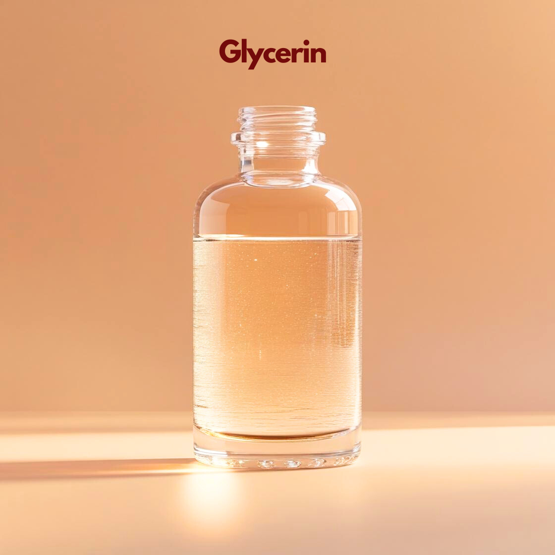 A clear glass apothecary style bottle filled with Glycerin, a transparent, colorless and viscous liquid. The bottle is open at the top and sits against a soft peach background. Sunlight creates bright shimmers and long shadows through the liquid. The product name "Glycerin" is featured at the top in maroon.