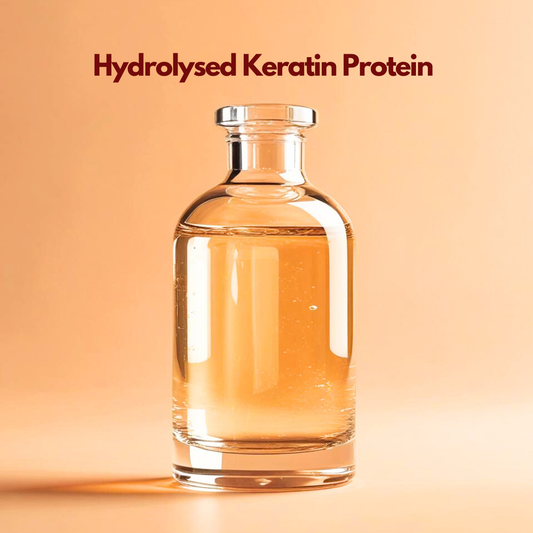Text of  Hydrolysed Keratin Protein showing a glass bottle with golden shadow alongside a silver cap Hydrolysed Keratin Protein for hair repair treatments and strengthening cosmetic products. 