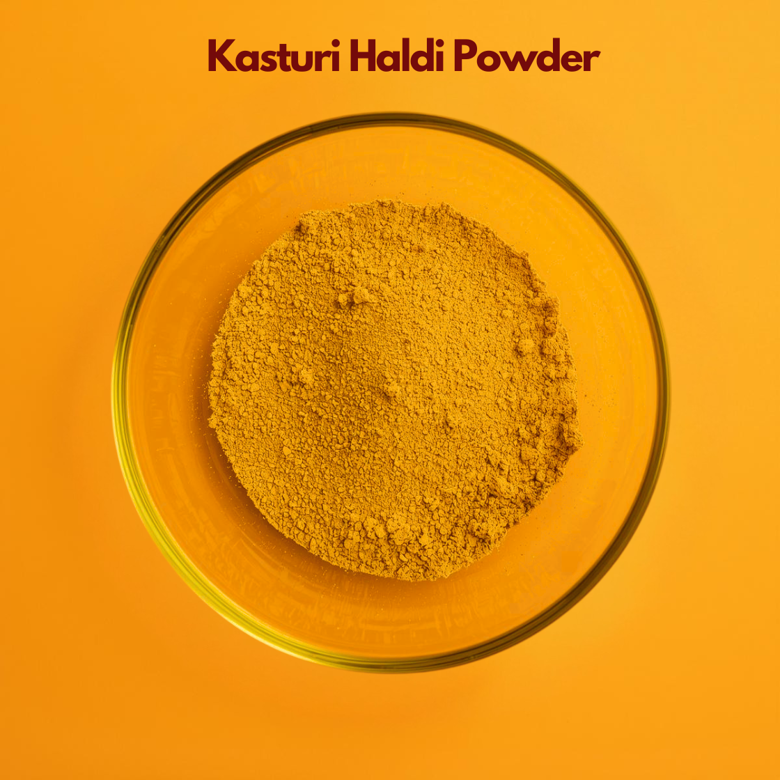 Overhead shot of Kasturi Haldi Powder in a clear glass bowl, showing vibrant yellow finely milled turmeric powder on a bright orange background. Wild turmeric herbal powder widely used in Ayurvedic skincare, anti-inflammatory face masks and natural cosmetic formulations.