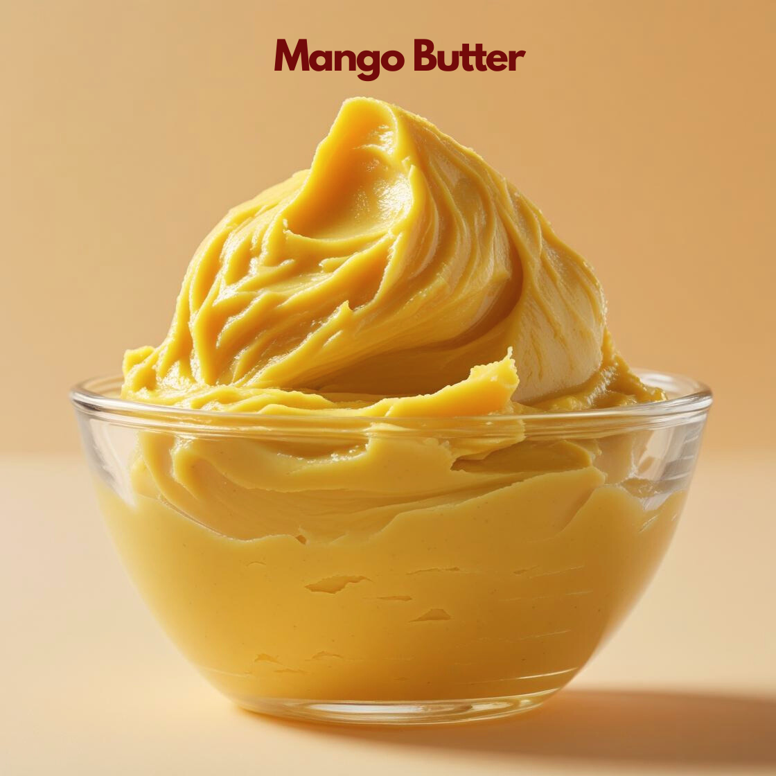 Mango Butter shown as a rich yellow whipped butter in a transparent glass bowl on a neutral background. Cosmetic use mango butter ideal for body lotions, hair masks and skincare formulations that support moisture retention and smooth texture.