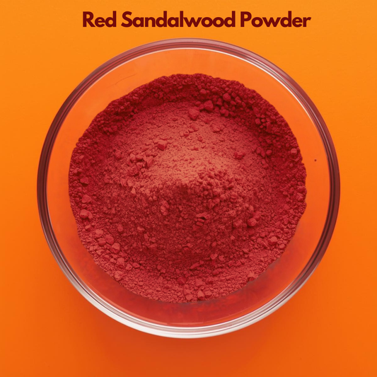 Overhead shot of Red Sandalwood Powder in a clear glass bowl, featuring rich deep red finely milled herbal powder on a bright orange background. Botanical herbal powder used in skincare for complexion enhancement, soothing treatments and cosmetic face pack formulations.