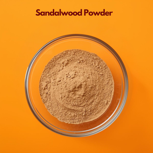 Top view of fine Sandalwood Powder placed in a clear glass bowl against a bright orange background, showing its smooth, light brown texture and soft earthy consistency. Natural Ayurvedic herbal powder commonly used in skincare for soothing, cooling and complexion enhancing face packs and cosmetic formulations.