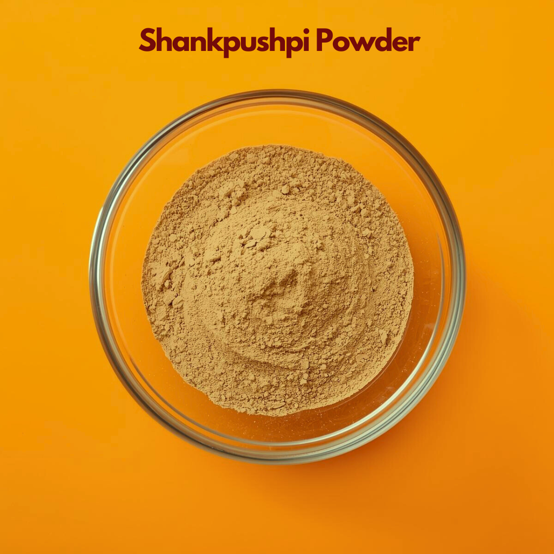 Top angle image of Shankpushpi Powder in a transparent bowl against a vibrant orange background, showing finely ground light brown herbal powder. Ayurvedic botanical powder used in traditional herbal preparations and natural cosmetic formulations.