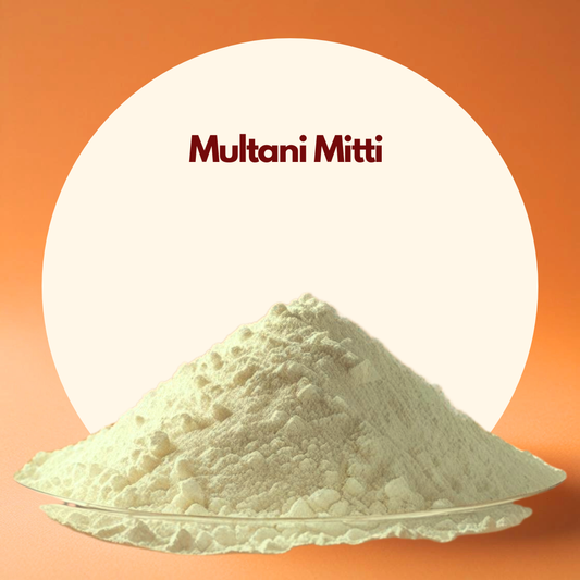 A mound of Multani Mitti powder on a reflective surface against an orange background with a large cream circle. The mood is natural and earthy.