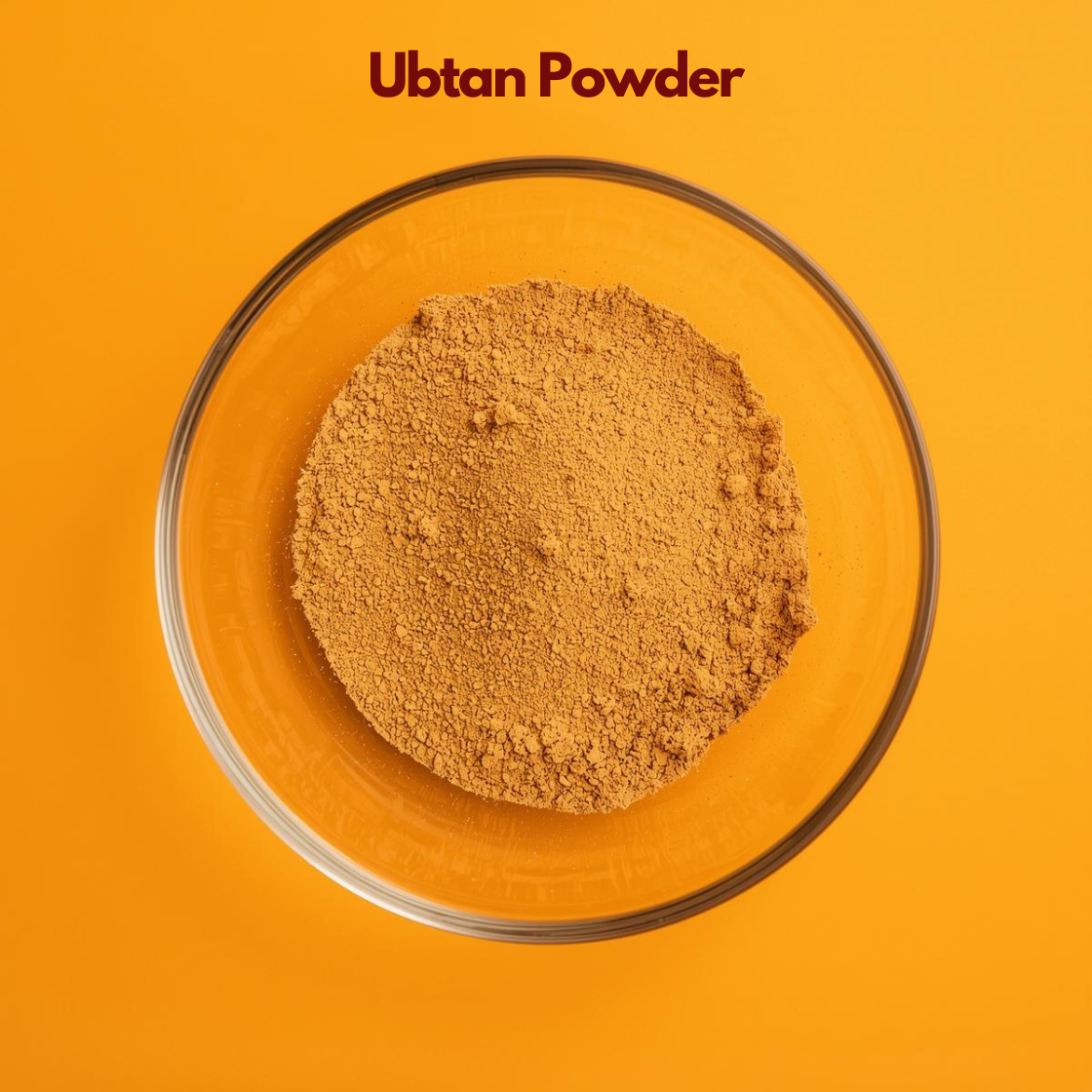 Top angle close up of Ubtan Powder in a transparent bowl, revealing fine golden-beige herbal powder with smooth, slightly grainy texture against an orange backdrop. Ayurvedic herbal face pack powder used for natural skin brightening, exfoliation and traditional skincare treatments.